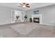 Spacious living room features a fireplace, ceiling fan, and elegant french doors at 2311 Lammermoor Ln, Indianapolis, IN 46214