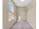 Carpeted walk-in closet with adjustable white shelving and a window providing natural light at 2311 Lammermoor Ln, Indianapolis, IN 46214