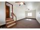 Open basement with stairs, neutral carpet, two ceiling fans and a window at 234 S East St, Pendleton, IN 46064