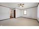 Carpeted bedroom with a ceiling fan, window, and neutral-toned walls at 234 S East St, Pendleton, IN 46064