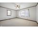 Well-lit bedroom featuring carpet, a ceiling fan, and two windows at 234 S East St, Pendleton, IN 46064
