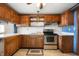Cozy kitchen with wooden cabinets, white tile backsplash, and stainless steel oven at 234 S East St, Pendleton, IN 46064