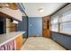 Eat-in kitchen features tile floor, wood cabinets, and lots of natural light at 234 S East St, Pendleton, IN 46064