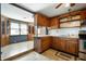 Eat-in kitchen featuring warm wood cabinetry, tiled floors, and open breakfast nook at 234 S East St, Pendleton, IN 46064