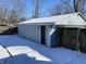 Exterior shot of a detached garage with snow on the ground with side entry at 2411 N Kitley Ave, Indianapolis, IN 46219