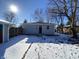 Exterior shot of the detached garage with snow on the ground and sun shining on the roof at 2411 N Kitley Ave, Indianapolis, IN 46219