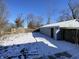Detached garage exterior shot in the winter with a fenced in back yard and overhead power lines at 2411 N Kitley Ave, Indianapolis, IN 46219