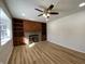 Spacious living room with a wood-burning fireplace, built-in shelving, and modern wood flooring at 2411 N Kitley Ave, Indianapolis, IN 46219