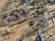 Aerial view highlights multiple homes among fields, mature trees, long shadows, and private driveways at 24535 Jerkwater Rd, Sheridan, IN 46069