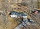 Aerial view of a home on a large lot with outbuildings, trees, and a long private drive at 24535 Jerkwater Rd, Sheridan, IN 46069