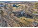 An aerial shot showcases the home's setting among mature trees and surrounding neighbors at 24535 Jerkwater Rd, Sheridan, IN 46069