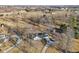 An aerial view of the property showcasing the house, large yard, driveway, and surrounding mature trees at 24535 Jerkwater Rd, Sheridan, IN 46069