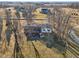 A beautiful aerial view highlights the backyard's gazebo, patio, mature trees, and surrounding yard at 24535 Jerkwater Rd, Sheridan, IN 46069