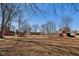 Large, open backyard with mature trees, play set, and outbuildings, perfect for Gathering fun and relaxation at 24535 Jerkwater Rd, Sheridan, IN 46069