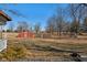 A large lot with an outbuilding and playset, seen from the back porch of the home at 24535 Jerkwater Rd, Sheridan, IN 46069