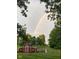 Scenic view of a charming red barn set against a vibrant rainbow backdrop at 24535 Jerkwater Rd, Sheridan, IN 46069