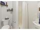 Functional bathroom featuring toilet, shower, and open shelving for storage at 24535 Jerkwater Rd, Sheridan, IN 46069