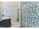 Bathroom with floral shower curtain and vanity sink with cabinet at 24535 Jerkwater Rd, Sheridan, IN 46069