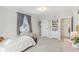 Neutral bedroom with a bed, window with gray curtains, and built-in shelving at 24535 Jerkwater Rd, Sheridan, IN 46069