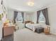 Cozy bedroom featuring a twin bed, gray curtains, and neutral decor at 24535 Jerkwater Rd, Sheridan, IN 46069