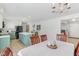 Dining room open to kitchen with white tablecloth, view of kitchen island at 24535 Jerkwater Rd, Sheridan, IN 46069