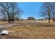 A picturesque home nestled on a sprawling lot with mature trees and a long driveway at 24535 Jerkwater Rd, Sheridan, IN 46069