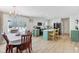 Bright kitchen with white cabinets, stainless steel appliances, eat-in island, with a view to the outside and dining area at 24535 Jerkwater Rd, Sheridan, IN 46069