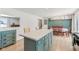 Kitchen island in open-concept kitchen/dining area, light wood floors at 24535 Jerkwater Rd, Sheridan, IN 46069