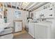 Bright laundry room with a washer, dryer, cabinets, and a window at 24535 Jerkwater Rd, Sheridan, IN 46069