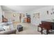A cozy living room that boasts soft gray carpet, a comfy sofa, a piano, and a unique blend of classic and modern decor at 24535 Jerkwater Rd, Sheridan, IN 46069