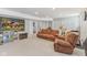 Finished basement with a large brown sectional, fireplace, and carpeted floors at 24535 Jerkwater Rd, Sheridan, IN 46069