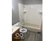 Bathroom features a white tiled shower and tub combo with a neutral colored vanity at 2454 Winfield Ave, Indianapolis, IN 46222