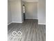 Living room featuring new vinyl flooring, light grey paint and contrasting dark doors at 2454 Winfield Ave, Indianapolis, IN 46222