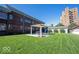 Expansive backyard with lush green lawn, covered patio, and detached garage at 3034 N Pennsylvania St # 1, Indianapolis, IN 46205