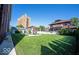 Backyard featuring a concrete patio with pergola, seating, and well-manicured lawn and buildings at 3034 N Pennsylvania St # 1, Indianapolis, IN 46205