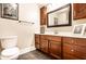 Cozy bathroom with dark wood cabinets, tile floors, and decorative accents at 3034 N Pennsylvania St # 1, Indianapolis, IN 46205