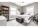 Comfortable bedroom with light-filled windows and a cozy floral quilt at 3034 N Pennsylvania St # 1, Indianapolis, IN 46205