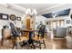 Charming dining area with a stylish chandelier, a blue tray ceiling and a view to the living room at 3034 N Pennsylvania St # 1, Indianapolis, IN 46205