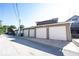 Garages behind the building with white doors along the back alley at 3034 N Pennsylvania St # 1, Indianapolis, IN 46205
