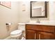 Half bathroom with a wooden vanity and framed mirror above the sink at 3034 N Pennsylvania St # 1, Indianapolis, IN 46205