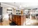 Large kitchen island with granite countertops, a dishwasher, and a view to the dining and living area at 3034 N Pennsylvania St # 1, Indianapolis, IN 46205