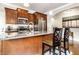 Modern kitchen with granite countertops, stainless steel appliances, and a convenient breakfast bar area at 3034 N Pennsylvania St # 1, Indianapolis, IN 46205