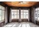 Sunroom with gray curtains, wooden ceiling, and brick walls at 3034 N Pennsylvania St # 1, Indianapolis, IN 46205