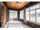Bright sunroom with brick walls, wood ceiling, tile floor, and multiple windows at 3034 N Pennsylvania St # 1, Indianapolis, IN 46205