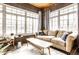 Cozy sunroom featuring brick walls, wood ceiling, and comfortable seating area at 3034 N Pennsylvania St # 1, Indianapolis, IN 46205