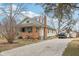 This home features a gravel driveway, a brick chimney, and vinyl siding at 3103 S Lockburn St, Indianapolis, IN 46221
