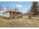 Quaint home with front porch, set on a lot with mature trees, and some landscaping at 3103 S Lockburn St, Indianapolis, IN 46221