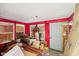 This living room has lots of work to be done to bring it back to a comfortable space at 3103 S Lockburn St, Indianapolis, IN 46221