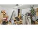 Cluttered room with bare floors and a drop ceiling at 3103 S Lockburn St, Indianapolis, IN 46221