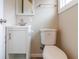 Cozy half bathroom with white vanity, mirror, and toilet at 3419 Carrollton Ave, Indianapolis, IN 46205